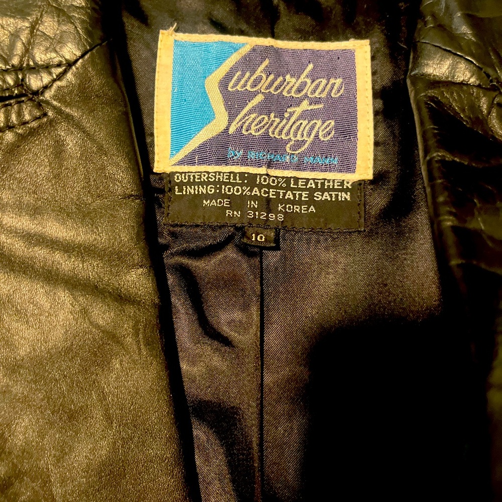Women’s size 10 vintage “Suburban Heritage” long fitted black leather jacket